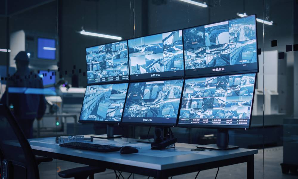 A CCTV room of a business with six display screens, each monitoring various parts of the business.