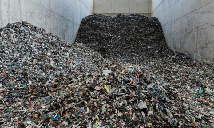 A large pile of plastic waste and electronics material that’s been discarded and collected for disposal.