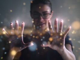 A young woman is using the latest technology, an augmented-reality hologram that's attached to her fingertips.