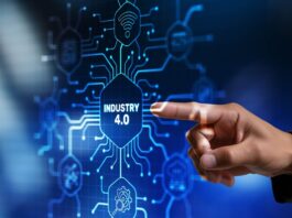 A hand points to a digital interface displaying “Industry 4.0” surrounded by connected technology icons and circuit graphics.