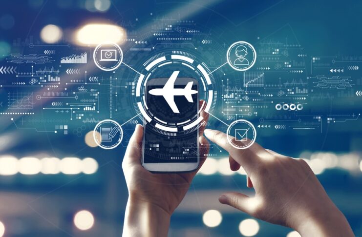 A person holding a smartphone displaying a digital airplane icon with futuristic travel technology interface overlays and connected smart travel features in the background.