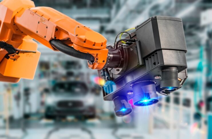 An industrial robot uses a machine vision camera system to inspect components on a modern automotive factory floor.